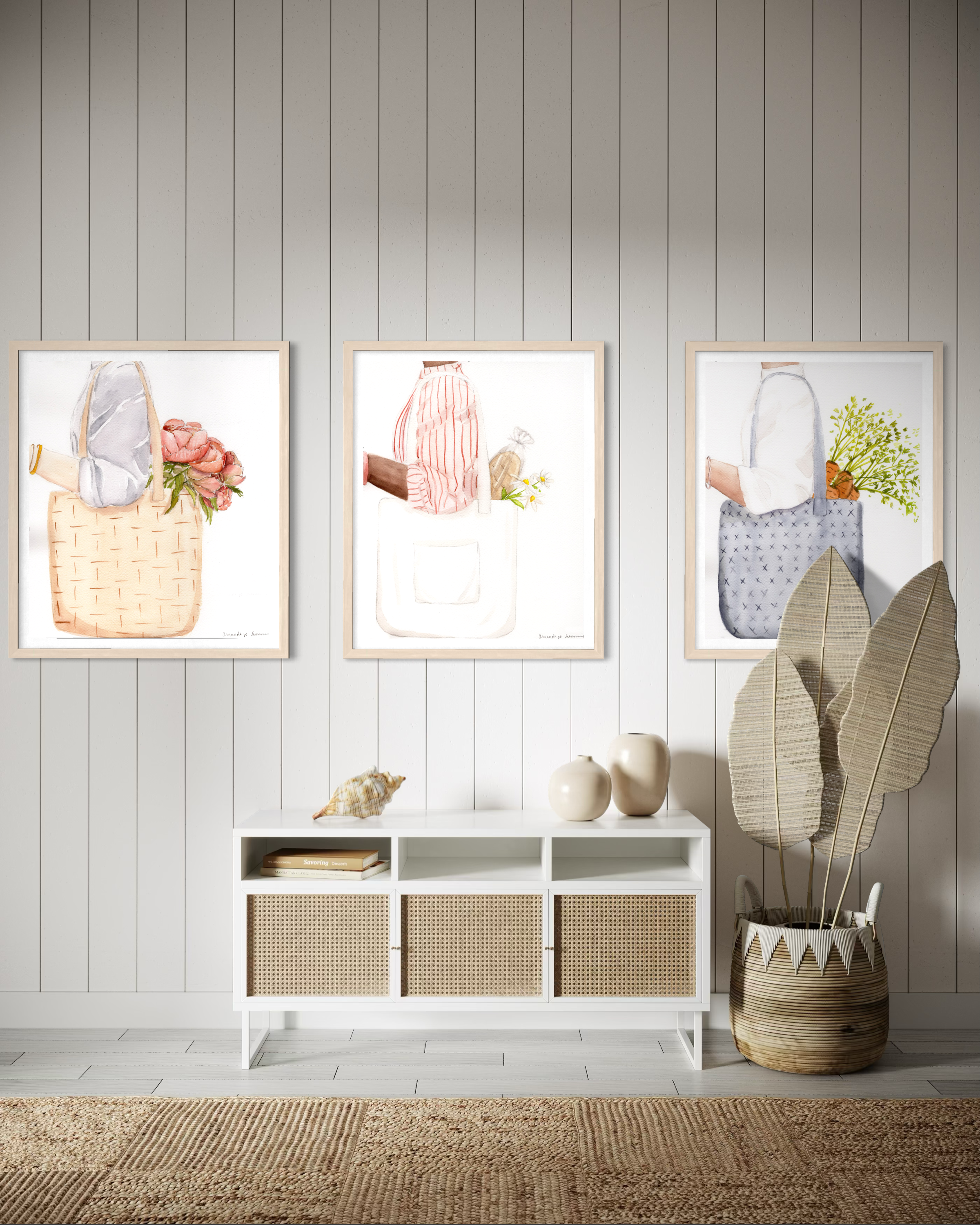 A triptych display of three minimalist watercolor paintings staged side-by-side on a neutral off-white wall. The collection, titled the Farmers Market Collection, features hand-painted illustrations of market totes with a spring aesthetic. The left panel shows a woven straw tote with coral peonies; the center panel shows a person in a red striped shirt carrying a white canvas tote with a baguette and daisies; and the right panel shows a blue textured bag with fresh carrots. The clean, modern gallery wall se