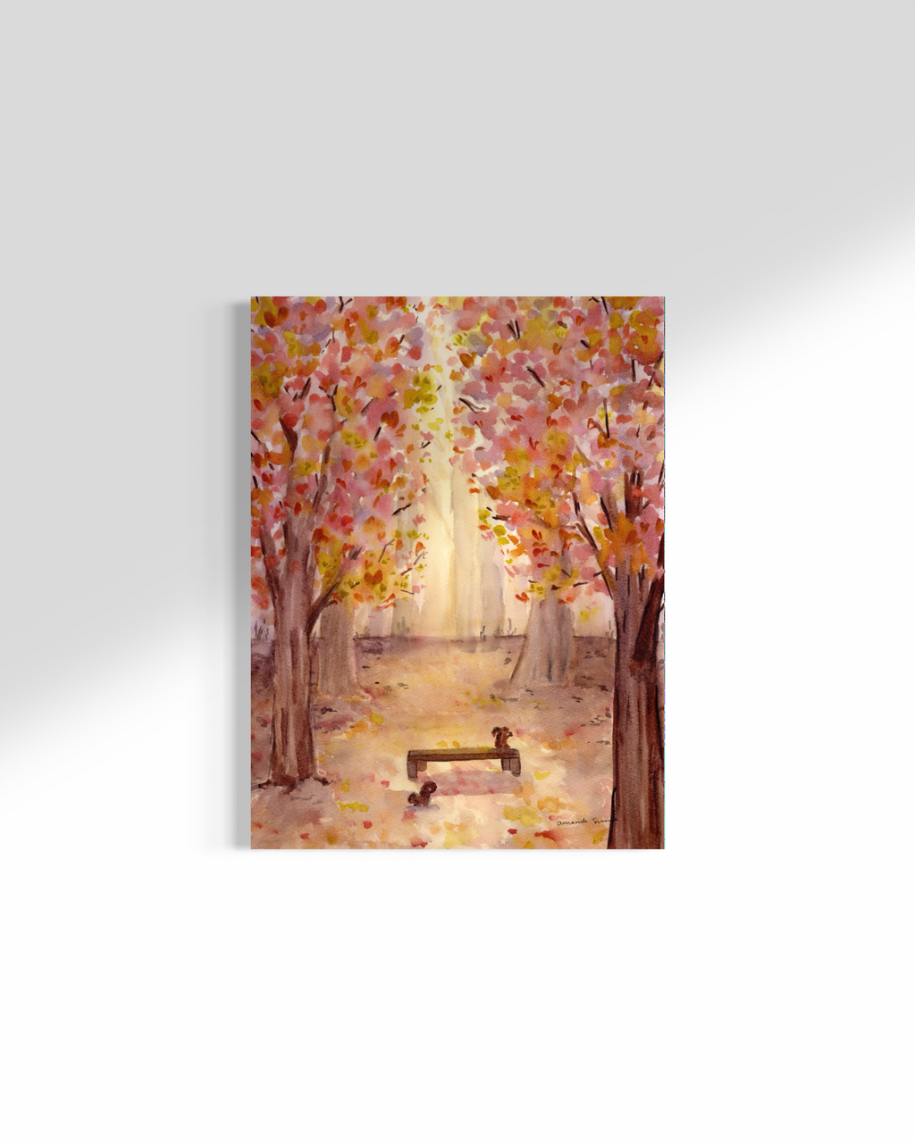 Original watercolor painting of a sunlit autumn forest path with vibrant pink, yellow, and orange foliage framing a wooden park bench with two squirrels.