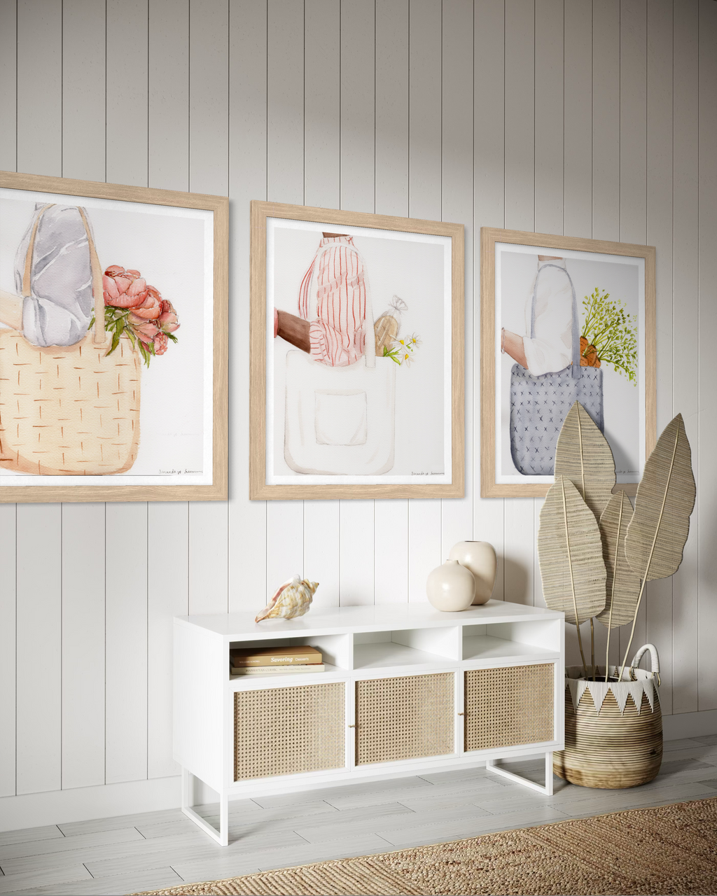 A triptych display of three minimalist watercolor paintings staged side-by-side on a neutral off-white wall. The collection, titled the Farmers Market Collection, features hand-painted illustrations of market totes with a spring aesthetic. The left panel shows a woven straw tote with coral peonies; the center panel shows a person in a red striped shirt carrying a white canvas tote with a baguette and daisies; and the right panel shows a blue textured bag with fresh carrots. The clean, modern gallery wall se