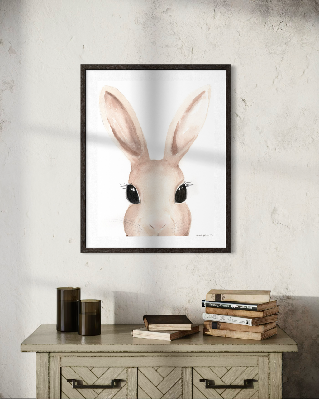 Close-up watercolor portrait of a rabbit with large, soft-wash ears and expressive dark eyes, rendered in sophisticated warm taupe tones on a clean white background. Perfect for a curated Easter art collection.