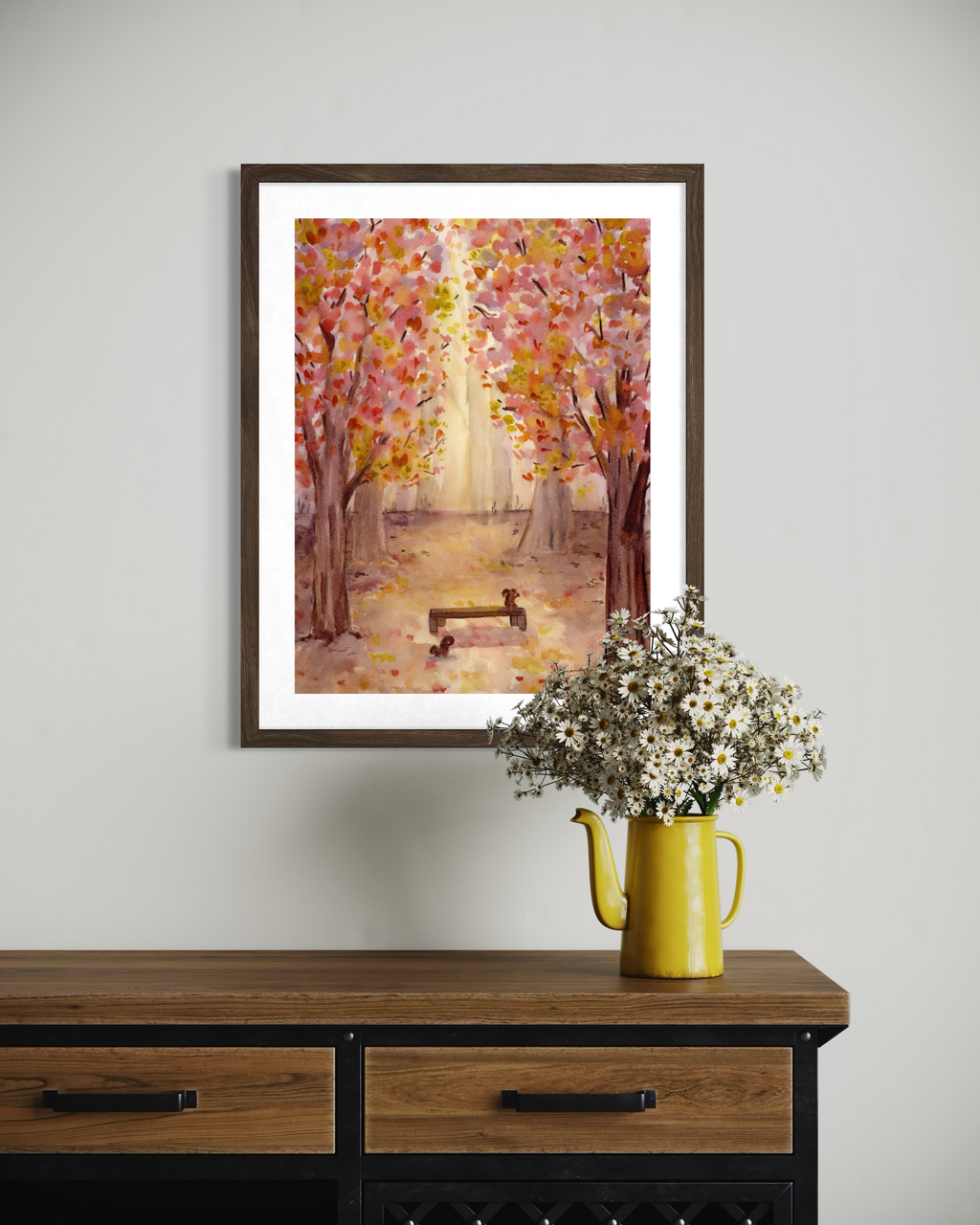 Original watercolor painting of a sunlit autumn forest path with vibrant pink, yellow, and orange foliage framing a wooden park bench with two squirrels.