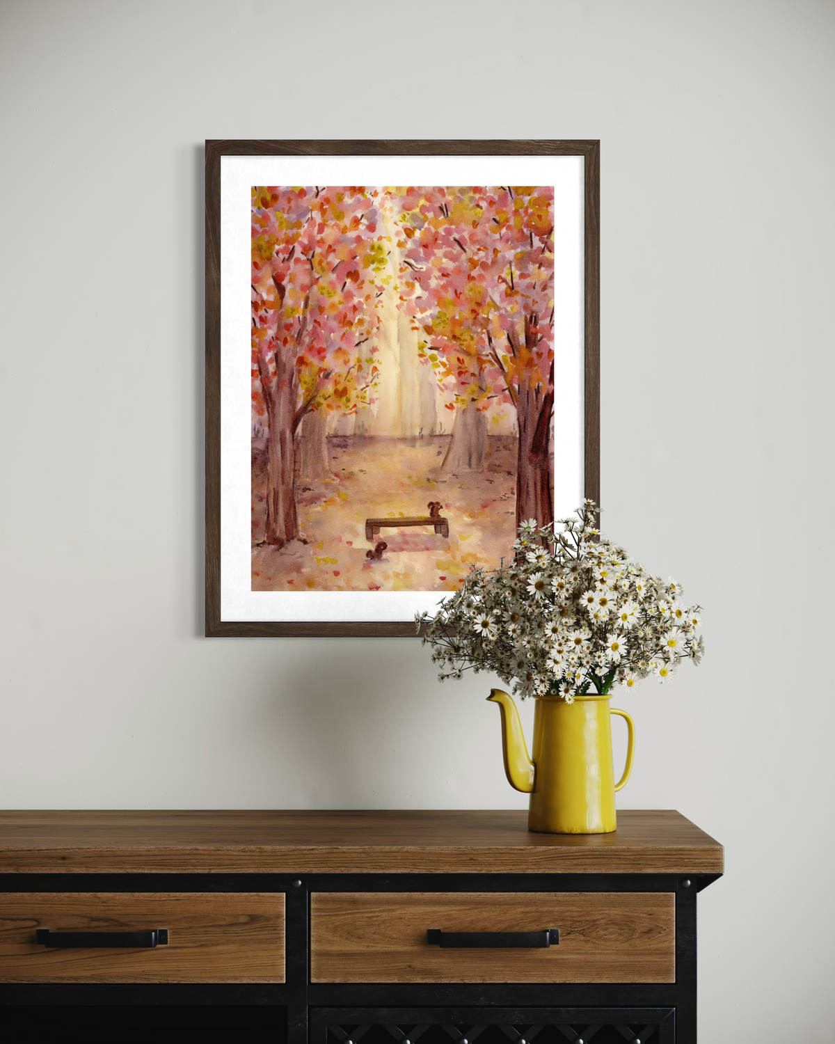 Original watercolor painting of a sunlit autumn forest path with vibrant pink, yellow, and orange foliage framing a wooden park bench with two squirrels.